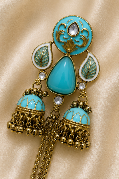 Azure Royale Twin Jhumka Earrings in antique gold finish with turquoise enamel, crystal accents and chain tassels by Rich Rose Jewellery.